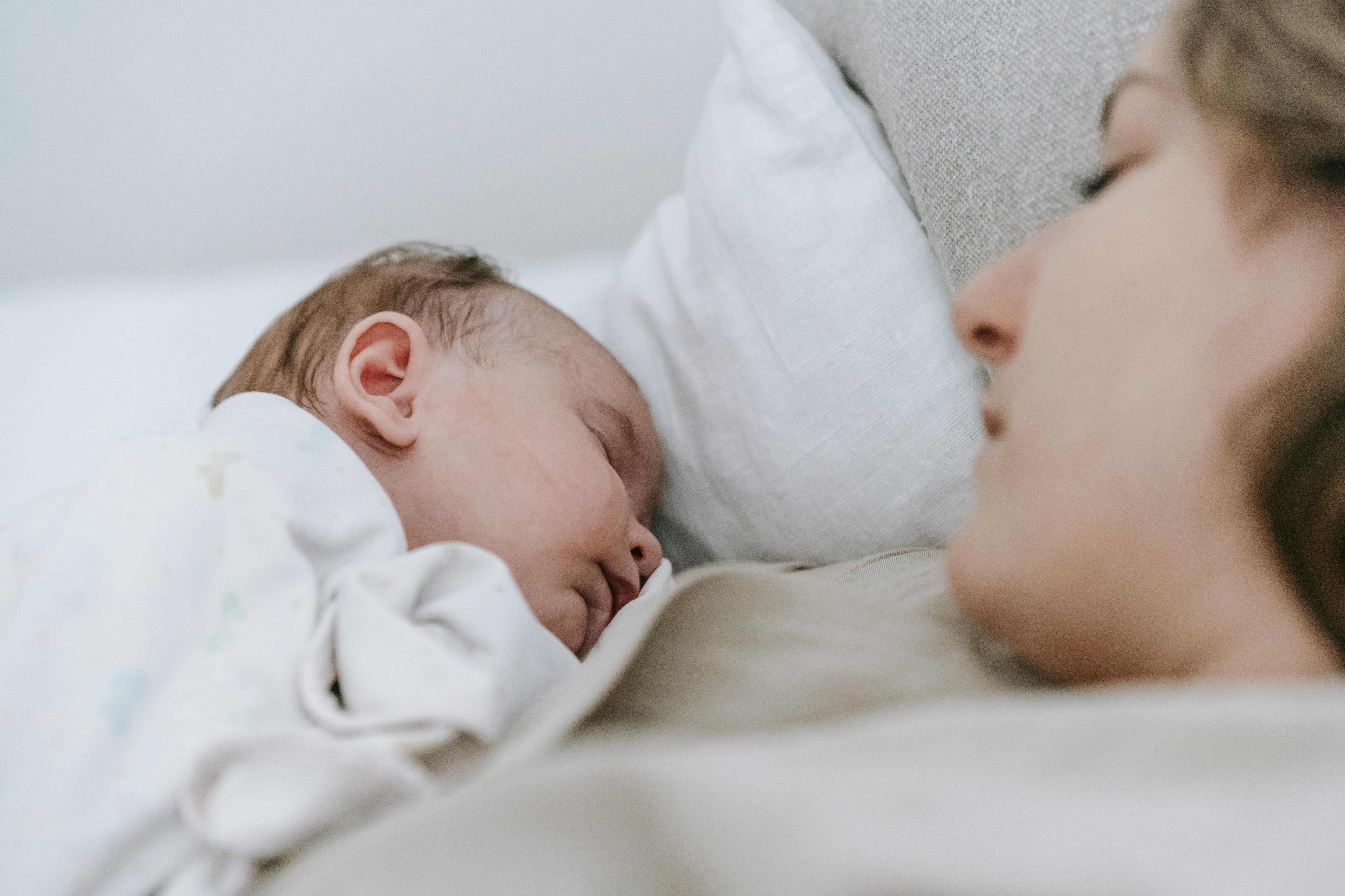 newborn sleeping on mothers chest