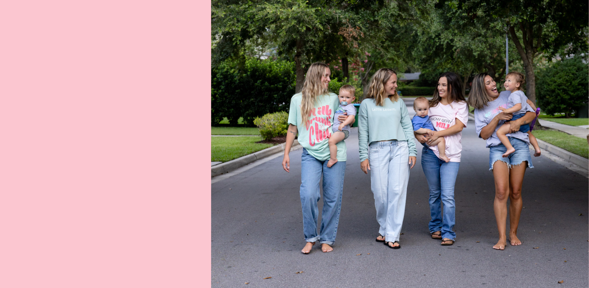 Four women walking down a street holding babies, with a pink vertical stripe on the left.