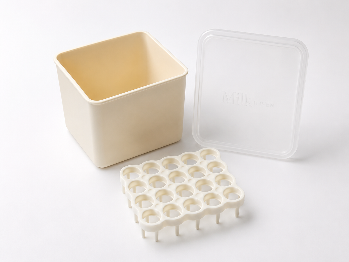 A cream square container with a clear silicone lid and a  cream plastic grid for tube stabilization, displayed on a clean white background.